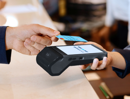 A payment card is tapped against a portable terminal